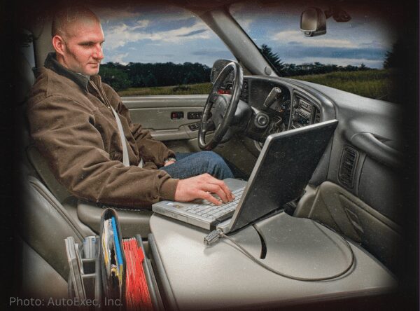 Case Manager working on a laptop from his vehicle