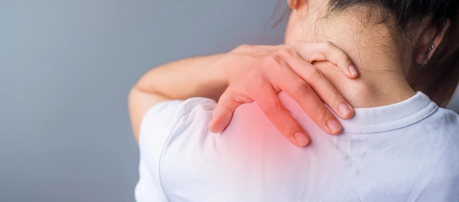 A woman holding a painful back.