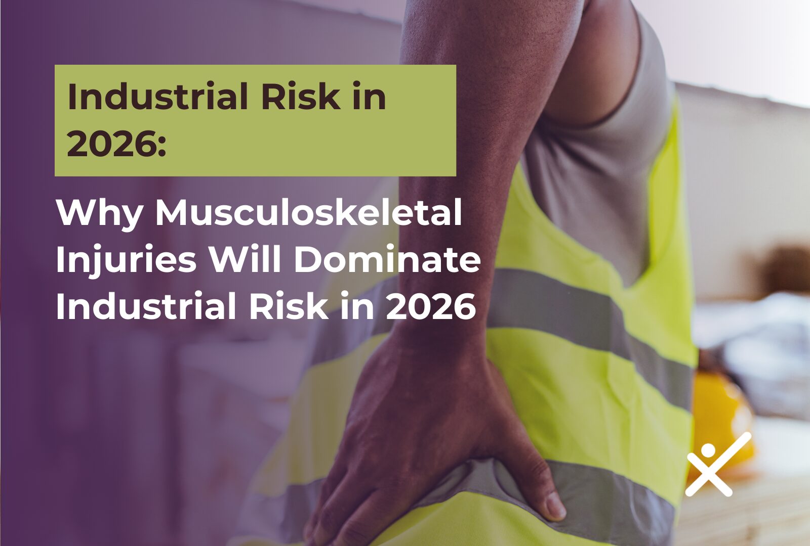 Worker in a safety vest holding their lower back after experiencing a musculoskeletal injury in their workplace