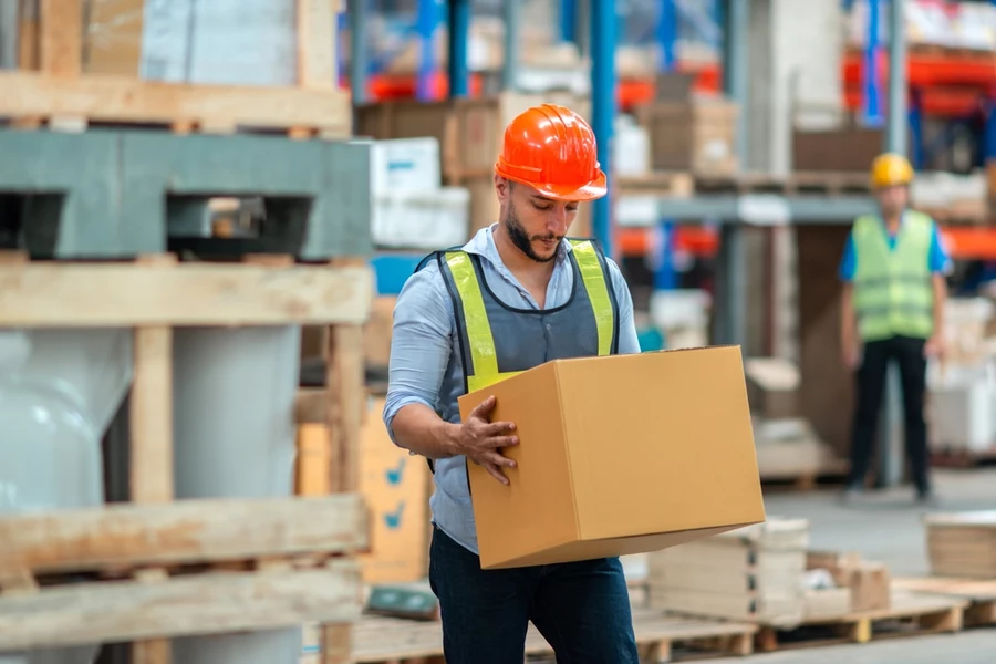 Warehouse worker carrying box
