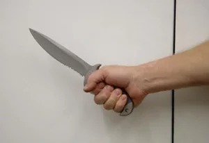 Hammer grip technique used for hanging cutting tasks to support a more neutral wrist position.