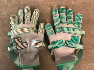 Wearable grip sensor glove used to measure hand force during repetitive cutting tasks in a poultry processing line.