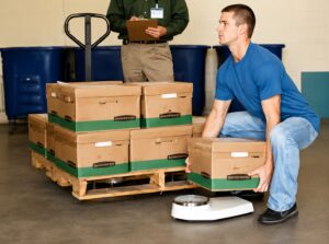 Job candidate completing a job-specific physical abilities test to assess safe lifting and manual material handling capabilities before employment.
